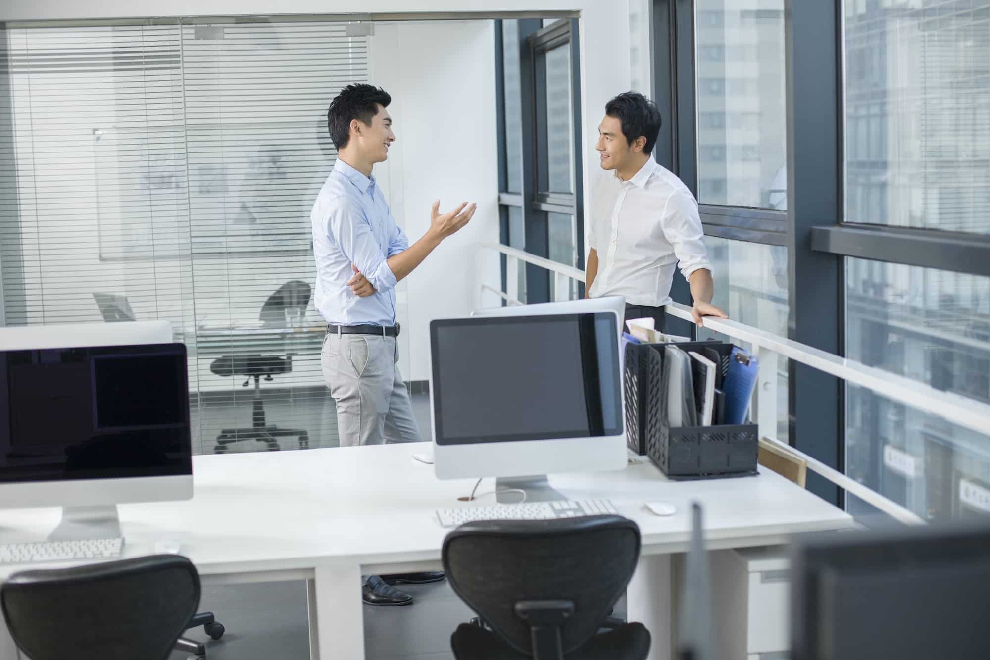 Young businessmen talking in office
